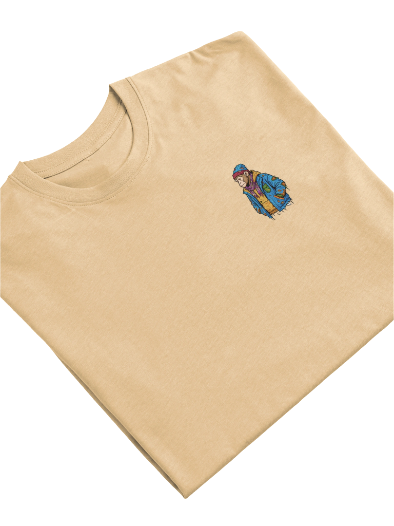The Unsolicited Scout Tee by Poor Monkey, folded in sand.